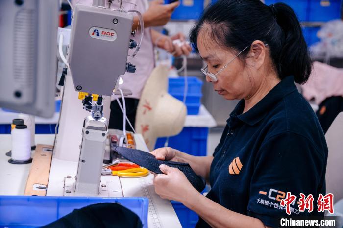 圖為員工在生產(chǎn)線工作?！±钅宪?攝